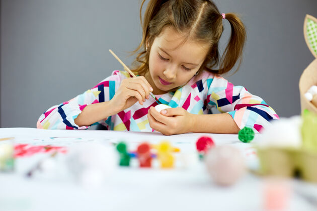 食物快乐的小女孩在家画画 用毛笔蛋画画孩子准备复活节 玩得开心 庆祝节日复活节快乐 diy画笔传统女孩