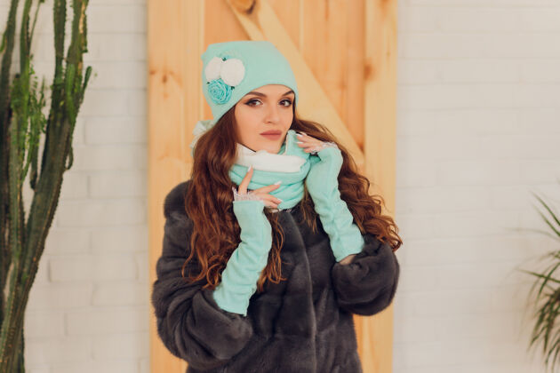 寒冷快乐美丽的女人侧身看着兴奋女孩戴着暖和的针织帽子和手套销售温暖冬季