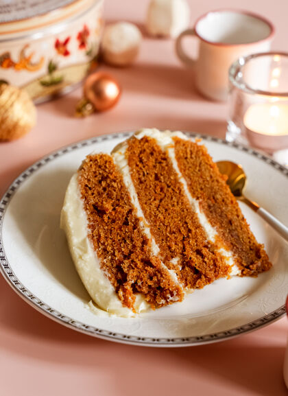 节日在白色盘子上放一块胡萝卜层蛋糕 有圣诞节的季节性背景前景美味膳食