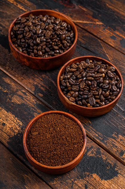 咖啡豆和磨碎的咖啡粉放在木头上桌面查看能量饮料香料
