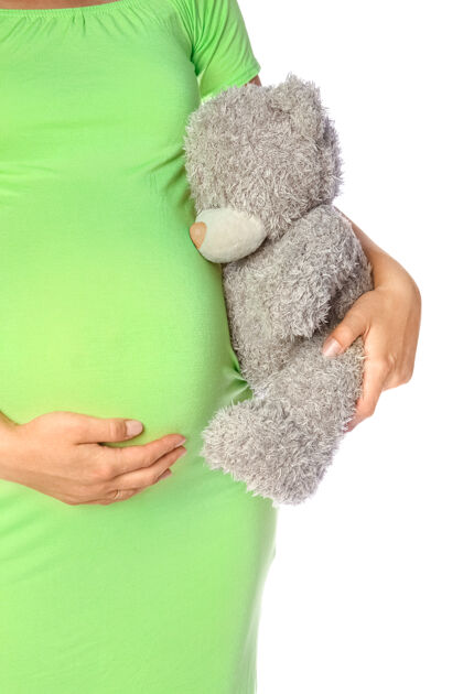 身体快乐的怀孕女孩躺在白色的背景上肚子父母怀孕