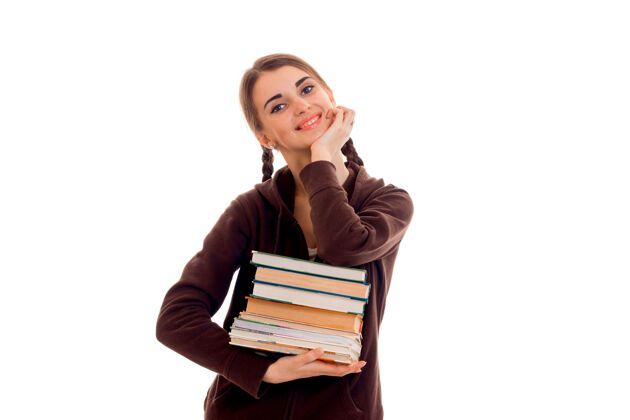 锻炼年轻漂亮的女学生 手里拿着很多书 孤零零地站在工作室的白墙上大学年轻大学