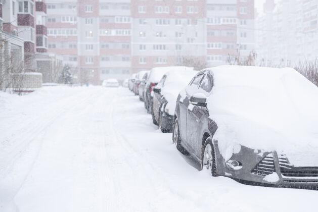 重冬天汽车被雪覆盖 外面有暴风雨霜冻暴风雪白天