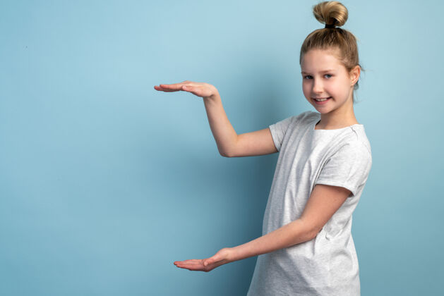 女性可爱 快乐 小女孩在蓝色墙上的复制空间展示概念青年头发人类