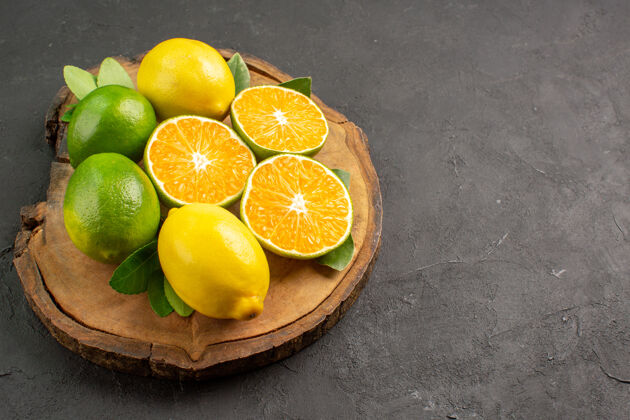 可食用水果前视图新鲜酸柠檬在黑暗的背景树健康柑橘