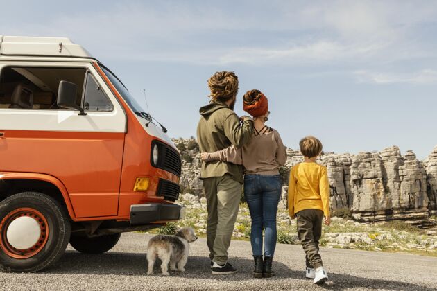 夫妇带狗旅行的家庭后视图父亲孩子汽车