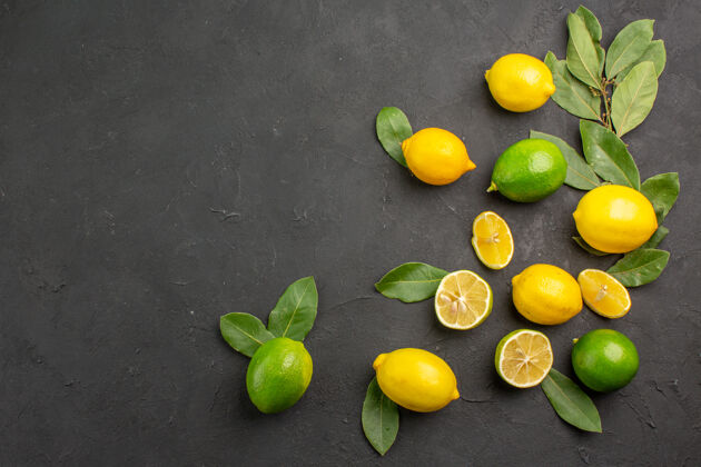 健康顶视图新鲜柠檬酸水果深色餐桌柑橘酸橙水果版面背景酸味