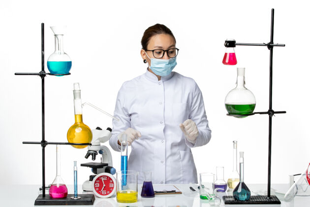 科学家白色地板上穿着医疗服戴着口罩的女化学家病毒化学实验室covid-splash医生化学面具
