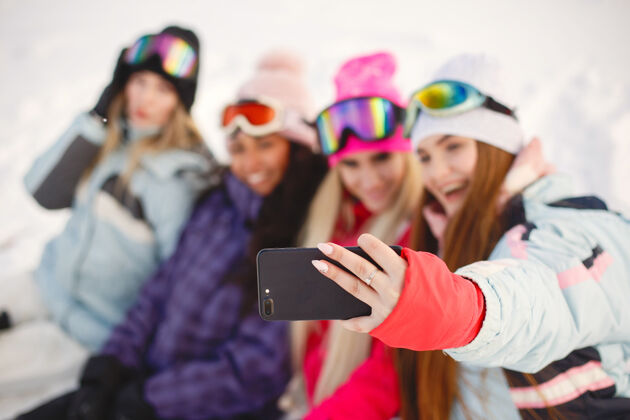 休闲滑雪器材在女孩们手里快乐的时光在一起女孩们学会滑雪白色紫色乐趣