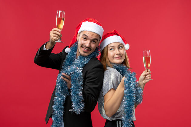 幸福前视图年轻夫妇庆祝新年在红墙党爱圣诞节表演者美丽圣诞节