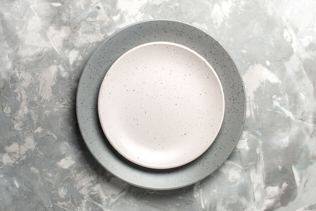 圆的灰色圆形空板顶视图 灰色表面上有白色板餐具面粉生的