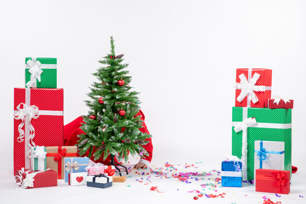 季节圣诞老人躲在白色背景装饰的圣诞树后面 节日气氛热烈隐藏圣诞圣诞老人