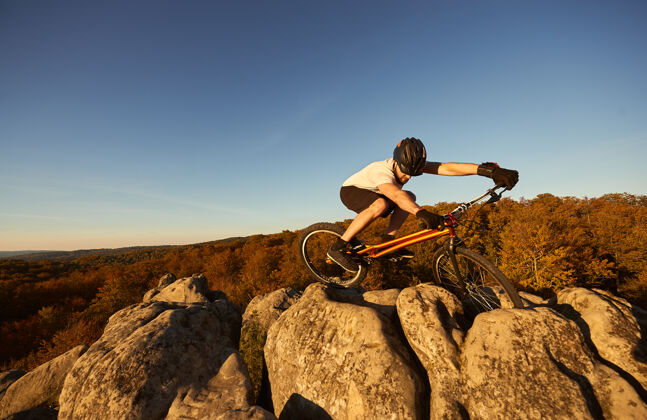极限在日落时分 职业自行车手在试骑自行车上保持平衡自行车自由式专业