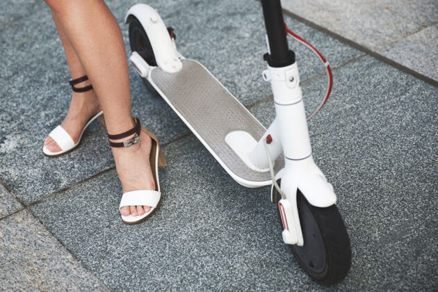 车辆电动滑板车上女性腿部特写镜头滑板车便利女孩