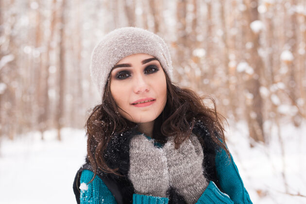吸引力在阳光明媚的日子里 年轻漂亮的女人在冬天的雪地公园里散步散步周末季节