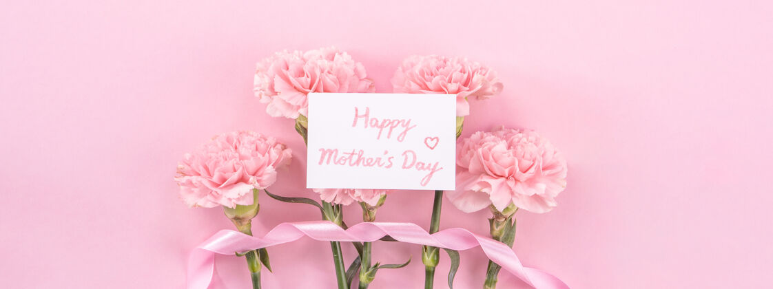 爱粉色康乃馨的俯视图 背景是粉色的母亲节花苍白束纸
