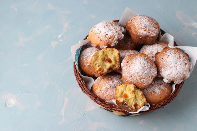 糖自制的杏干松饼 在柳条篮子里撒上糖粉 放在淡蓝色的上面早餐餐烹饪