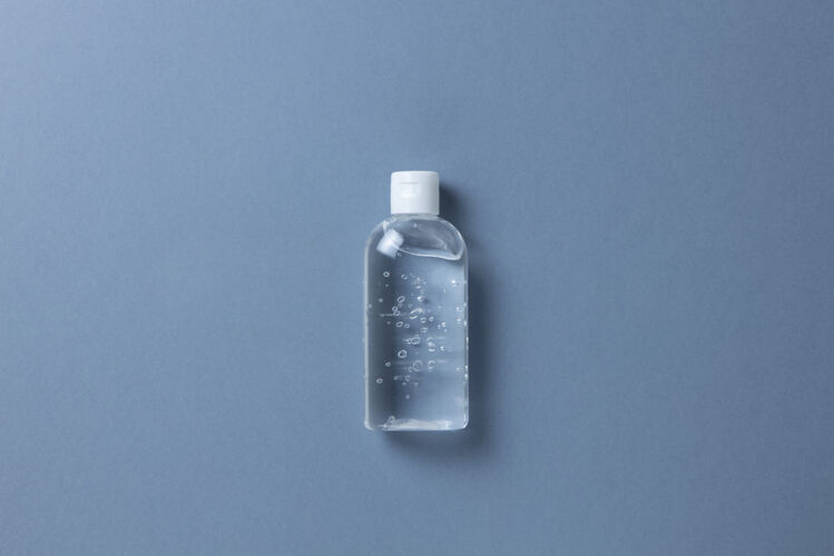 清洁透明瓶中的消毒凝胶 灰色背景药品流行病检疫