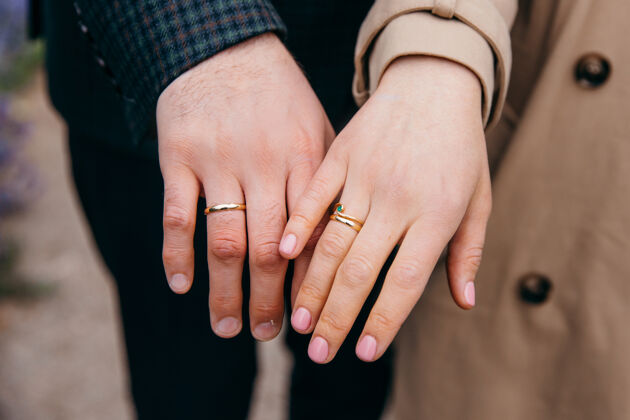 男朋友一对恩爱的情侣展示他们的结婚戒指手花浪漫