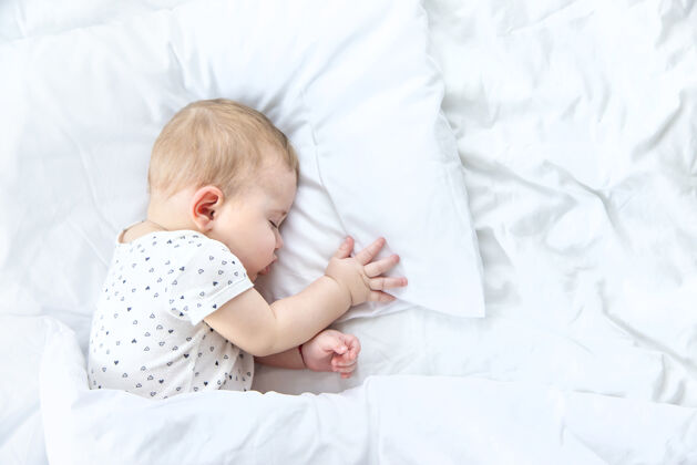 放松宝宝睡在白色的床上可爱室内梦