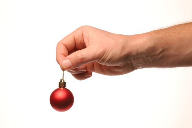手红球圣诞树装饰在手庆祝活动活动生活