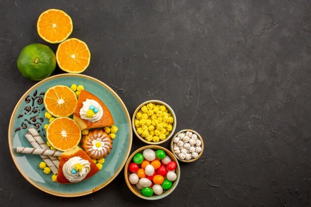 水果顶视图美味的派片与烟斗饼干和新鲜的橘子黑背景水果蛋糕甜饼干派新鲜芯片食品