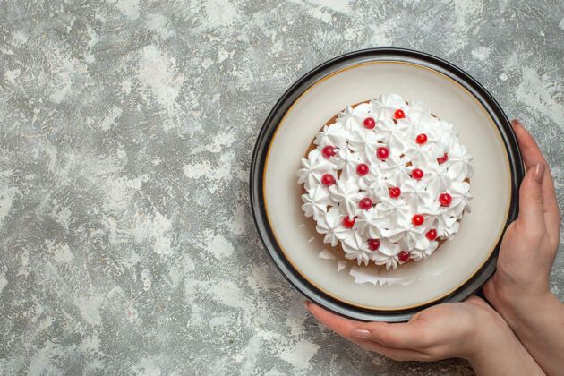 壁板上图：手拿一个盘子 上面放着美味的奶油蛋糕 上面装饰着水果过滤碗背景