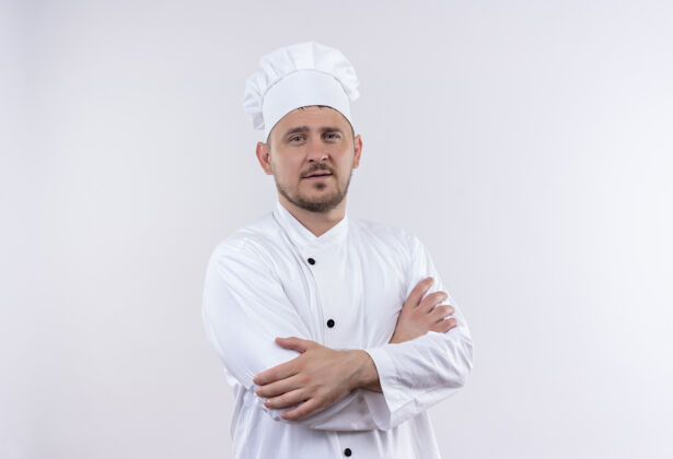制服自信的年轻帅哥厨师身着厨师制服 以封闭的姿势站在白色的墙上厨师站立姿势