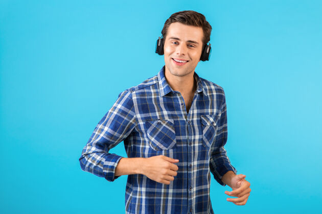 娱乐坐在蓝色耳机上听音乐的男人的画像立体声乐趣自信