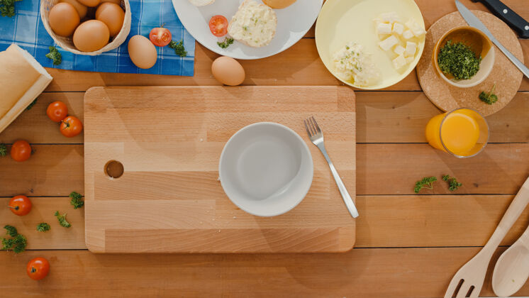 面粉年轻的亚洲女厨师的手把鸡蛋放进陶瓷碗里煮煎蛋木材碗早餐