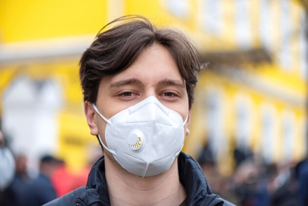 标语一个戴着医学面具的年轻人的肖像 在基希讷乌大楼前抗议临时选举的人们 摩尔多瓦抗议人民欺骗