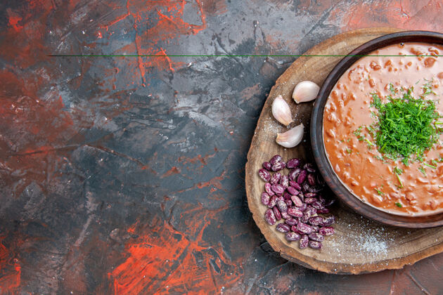 混合番茄汤豆蒜的半张照片放在调色台的木砧板上番茄汤脏一半