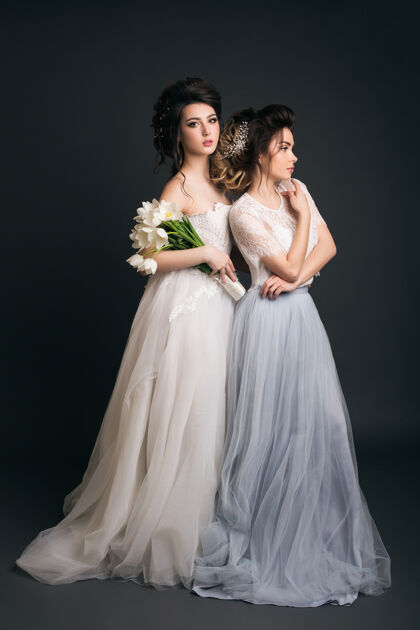 模特两个穿着婚纱的年轻漂亮时髦的女人人快乐优雅