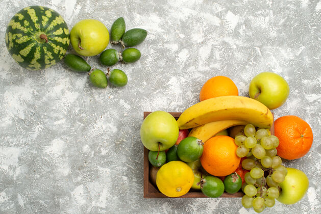 顶部顶视图新鲜水果组成香蕉葡萄和白底飞珠 水果成熟醇厚 维生素健康新鲜观点水果饮食