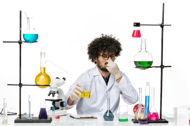 职业前视图穿着医疗服的男性化学家拿着白色空间上的溶液外套化学专业