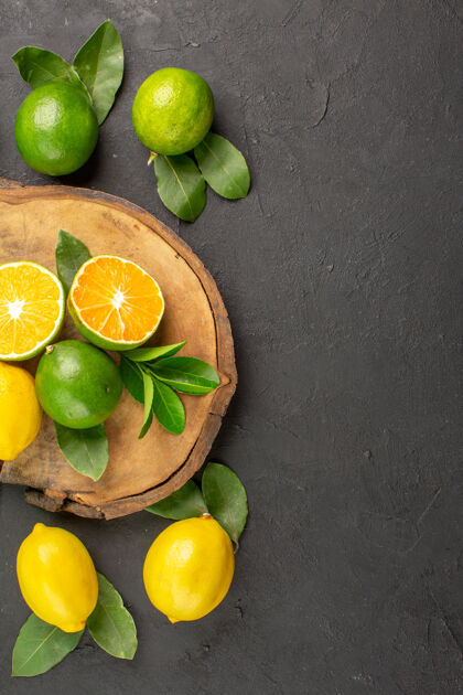 食物顶视图新鲜柠檬上深色的餐桌酸橙酸水果柑橘新鲜柠檬水果酸橙