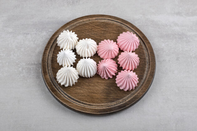 零食粉色和白色的蛋白酥皮放在木板上 放在大理石桌上配料甜点卡路里