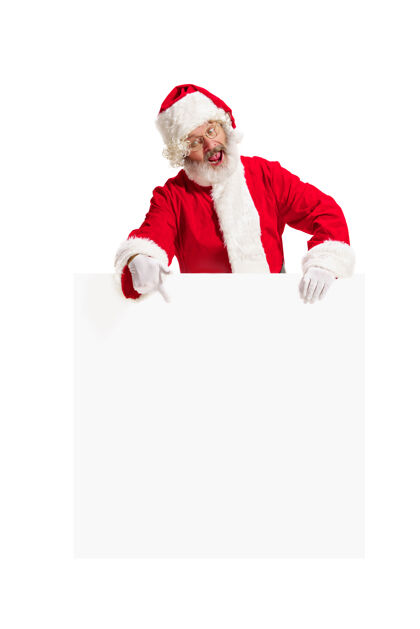 惊喜快乐惊喜的圣诞老人指着空白的广告横幅背景和复制空间微笑的老人在白色空白的空白海报显示新的微笑圣诞老人