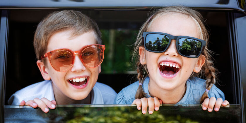 旅行可爱的孩子戴着大墨镜 笑容满面汽车男孩窗户