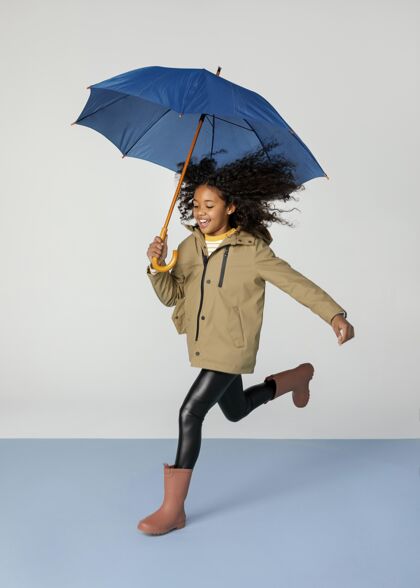孩子一个拿着伞跑的女孩全镜头肖像季节