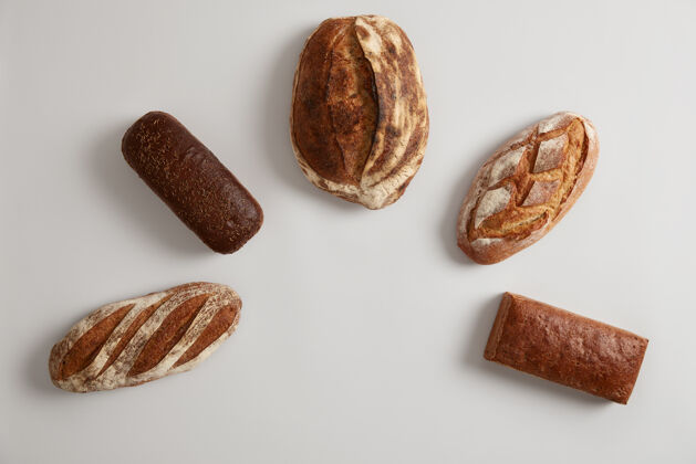 面包不同类型的新鲜有机面包在白色背景下呈半圆形排列全麦荞麦多粒黑麦面包在面包房烘焙乡村天然生物制品纤维平衡面包房