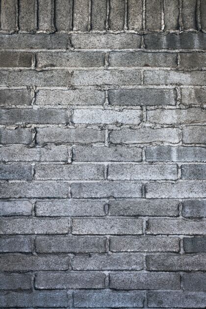 建筑用水泥砌成的灰色砖墙的垂直镜头水泥废弃的裂缝