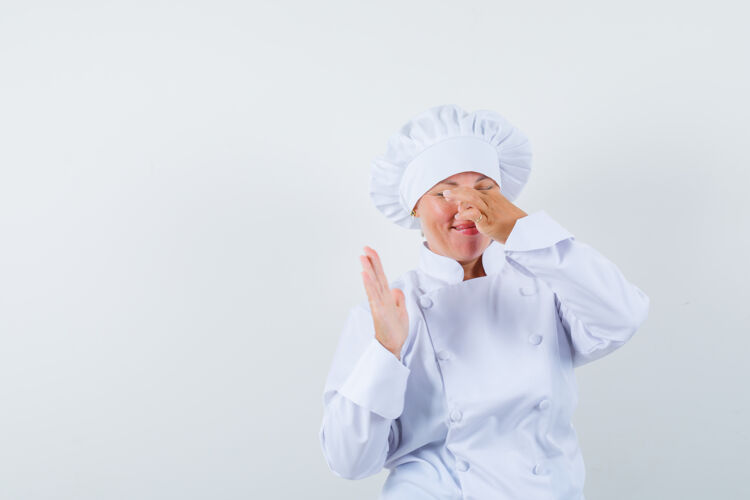 女性女厨师捏鼻子因臭味穿白色制服 看起来恶心时尚制服欢呼