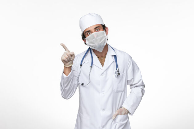 面罩正面图身穿医疗服的男医生戴着无菌口罩 以防止柯维德-白墙病毒疾病柯维德大流行疾病防护医生穿着