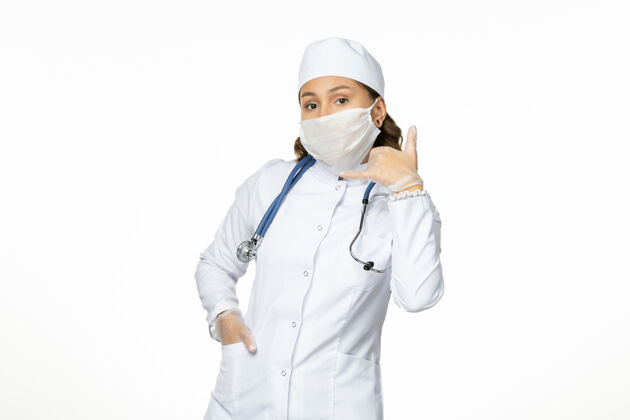 人员正面图女医生身穿白色医疗服 戴口罩 因白色办公桌上有冠状病毒大流行性疾病隔离冠状病毒套装前台药品
