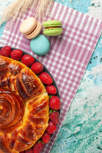 法国蓝色桌子上的草莓派和法国马卡龙马卡龙健康甜点