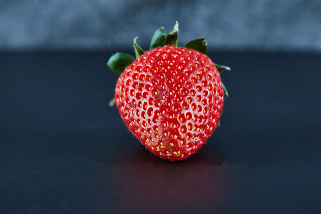 自然新鲜的红色草莓在黑暗的表面特写成熟新鲜多汁
