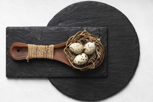 庆祝把复活节彩蛋平放在石板上的木勺里巢节日假日