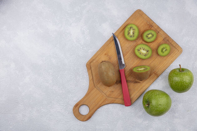 水果顶视图复制空间猕猴桃切片用刀在切纸板上绿色苹果白色背景新鲜切白色