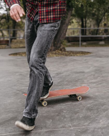 体育在公园外面玩滑板的人的正视图男性垂直娱乐